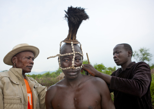 Bodi Man Putting Cauris Shell And Ostrich Plume Headgear On Before Kael New Year Ceremony Omo Valley Ethiopia