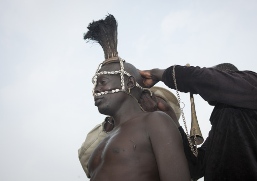 Bodi Man Putting Cauris Shell And Ostrich Plume Headgear On Before Kael New Year Ceremony Omo Valley Ethiopia