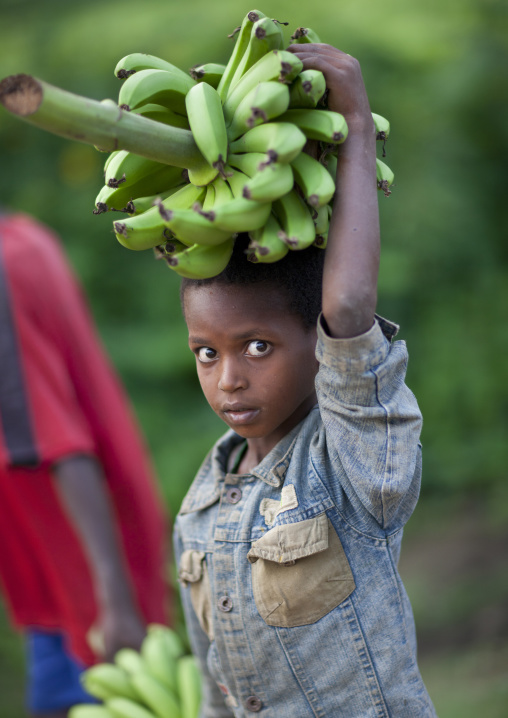 Young Boy With Green Bananas Bunch On His Head Ethiopia
