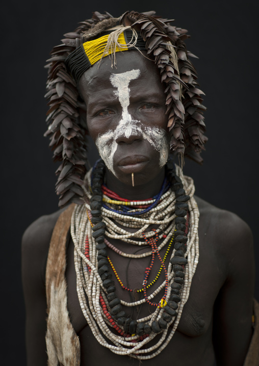 Painted Face Of Senior Karo Woman Wearing Traditional Headdress And Beaded Necklace Omo Valley Ethiopia