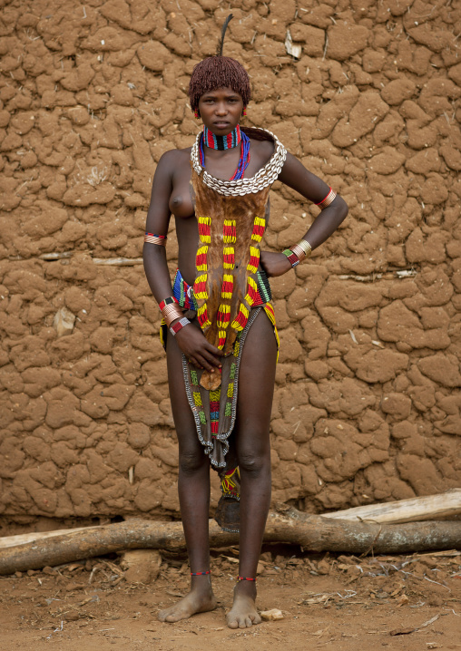 Hamer Beautiful Traditionally Dressed Hamer Tribe Woman Posing In Front Of Clay House Omo Valley Ethiopia