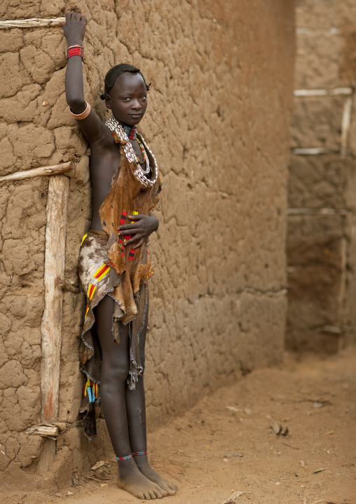 Hamer Beautiful Traditionally Dressed Hamer Tribe  Woman Posing In Front Of Clay House Omo Valley Ethiopia