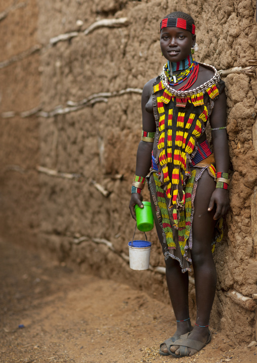 Hamer Teenage Girl With Traditional Clothing Outside A Clay House Omo Valley Ethiopia
