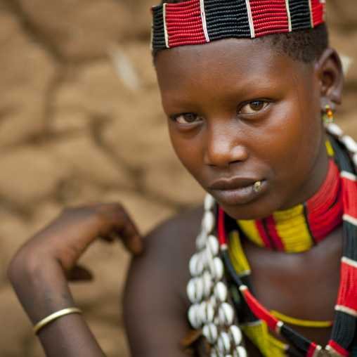 Portrait Of Hamer Beautiful Girl Posing In Front Of Clay House  Omo Valley Ethiopia