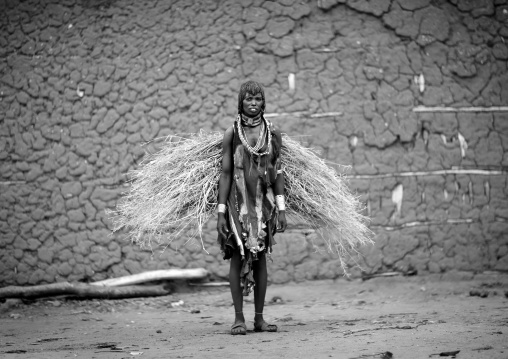 Hamer Woman With Load Of Straw On Her Back And Skin Clothing Omo Valley Ethiopia