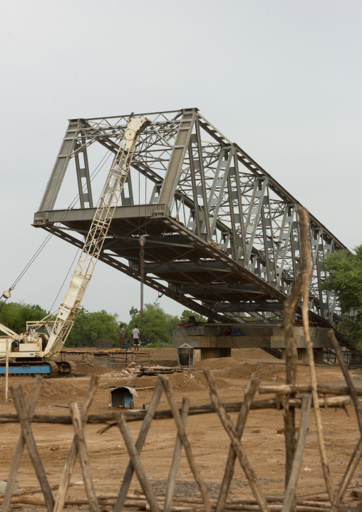 Metal bridge being built above omo river omo valley Ethiopia
