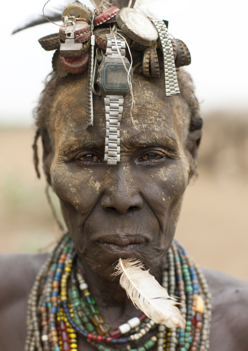 Senior Dassanech Woman Wearing Watch As Headdress And Feather In The Chin Portrait Omo Valley Ethiopia
