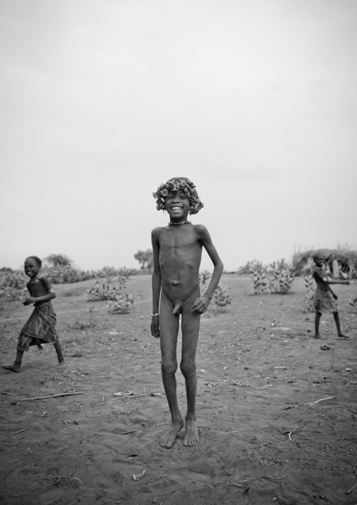 Young Laughing Dassanech Naked Boy With Bottle Cap Headgear Omorate Ethiopia