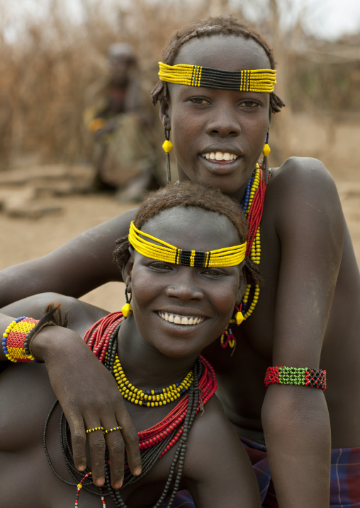 Couple Of Dassanech Teenage Girls With Beaded Ornaments Sitting On The Floor With Relaxed Expression Omo Valley Ethiopia