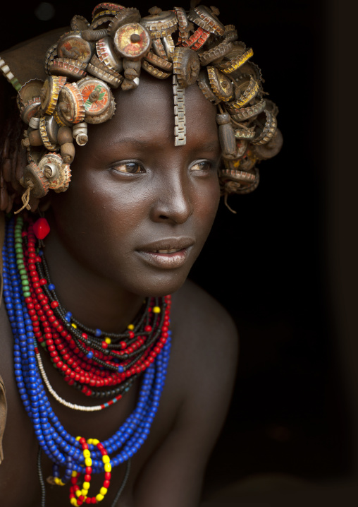Portrait Of A Young Dassanech Cute Woman Wearing Bottle Caps Headgear And Beaded Necklaces Omo Valley Ethiopia