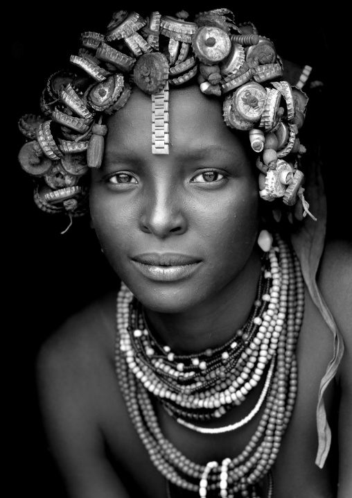 Portrait Of A Young Dassanech Cute Woman Wearing Bottle Caps Headgear And Beaded Necklaces Omo Valley Ethiopia