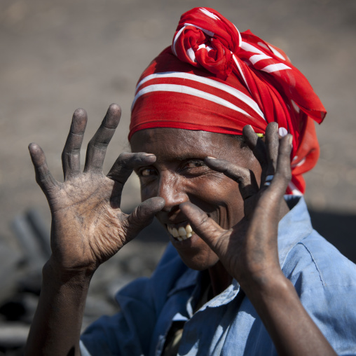 Old woman pretending to click with a photo camera, Adama, Ethiopia
