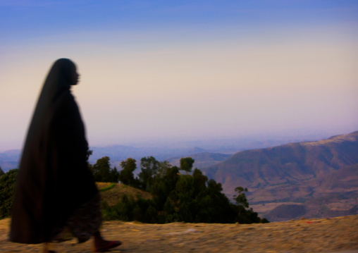 Silhouette Of A Woman Walking Along The Road Over Beautiful Landscape, Metehara, Ethiopia