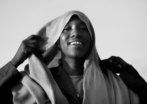Black And White Portrait Of A Oromo Woman With Toothy Smile Putting Back Her Headscarf, Dire Dawa, Ethiopia