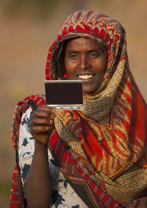 Portrait of a woman with toothy smile seing herself on picture for the first time, Dire dawa, Ethiopia