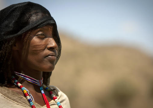 Profile Portrait Of A Smiling Karrayyu Tribe Woman With Facial Scarifications, Metahara, Ethiopia