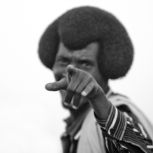 Black And White Portrait Of A Karrayyu Tribe Warrior With Gunfura Hairstyle Pointing Finger To The Camera, Metahara, Ethiopia