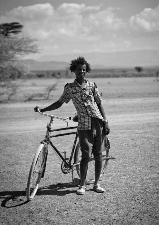 Black And White Portrait Of A Karrayyu Tribe Man With His Bike, Metahara, Ethiopia