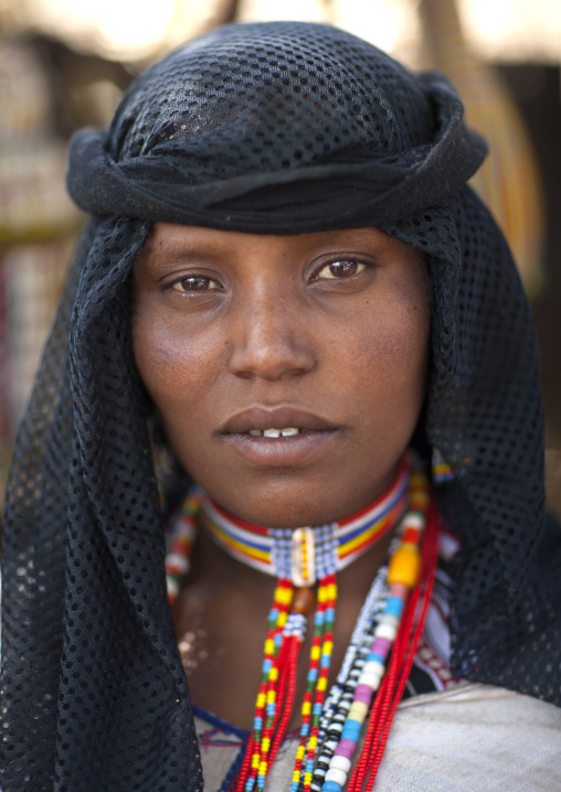 Portrait Of A Karrayyu Tribe Woman With Black Headscarf And Colourful Jewels At Gadaaa Ceremony, Metehara, Ethiopia