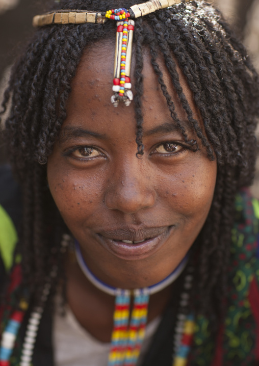 Smiling Karrayyu Tribe Woman With Stranded Hair And Colourful Jewels At Gadaaa Ceremony, Metehara, Ethiopia