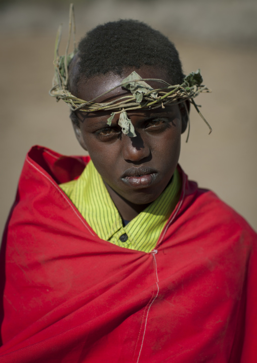 Portrait Of A Karrayyu Tribe Boy From The Former Ruling Family In Red Wrap Around Clothes And With Headband Made Out Of Branches During Gadaaa Ceremony, Metahara, Ethiopia