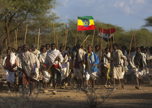 Group Of Karrayyu Tribe Men Walking With The Oromo And Ethiopian Flags, Gadaaa Ceremony, Metahara, Ethiopia