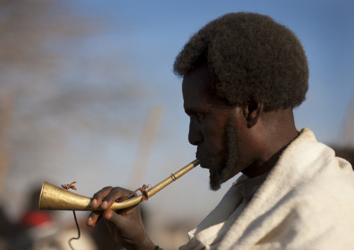 Profile Portrait Of A Karrayyu Man Blowing In Horn During Gadaaa Ceremony, Metehara, Ethiopia