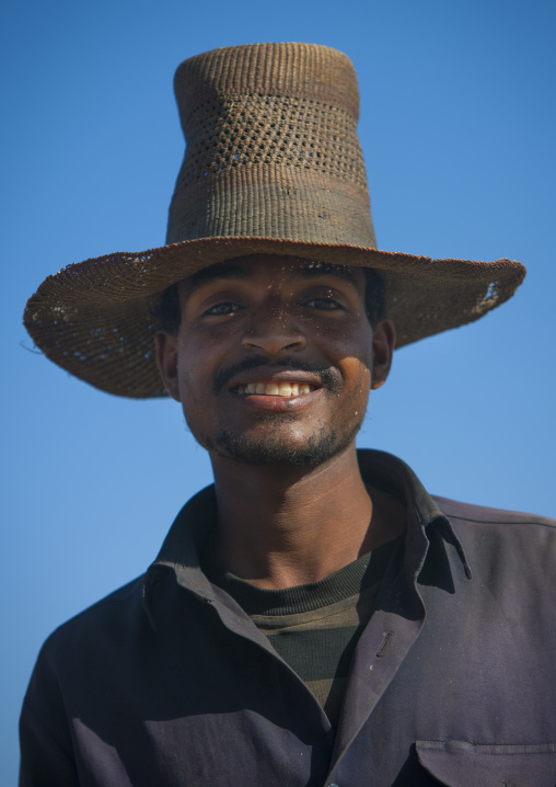 Portrait of a muslim man with toothy smile wearing a big hat, Alaba, Ethiopia