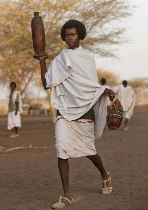 Young Karrayyu Tribe Man In Traditional Clothes And With Gunfura Hairstyle Bringing Gifts For The Gadaaa Ceremony, Metahara, Ethiopia
