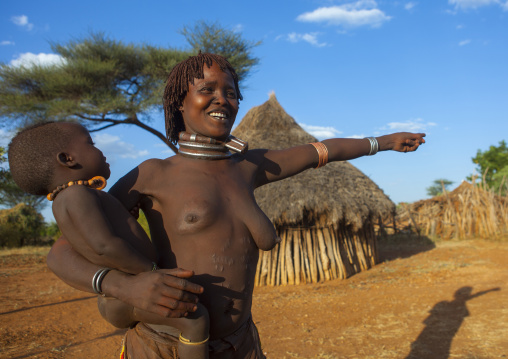 Hamer Tribe Woman Carrying Her Baby In Traditional Outfit, Turmi, Omo Valley, Ethiopia