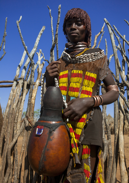 Girl Of The Hamer Tribe, In Traditional Outfit Holding A Calabash, Turmi, Omo Valley, Ethiopia