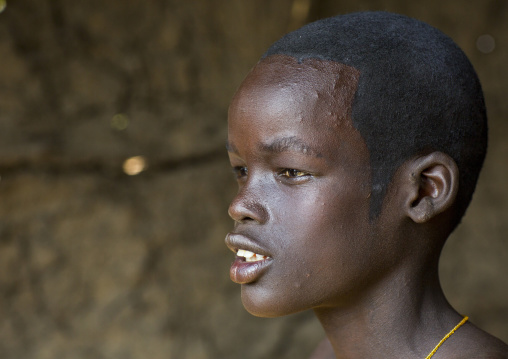 Nuer Tribe Teenager With A Make Up To Make A Traditional Hairstyle, Gambela, Ethiopia