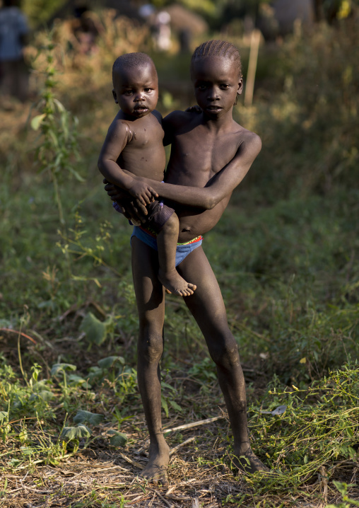 Anuak Child Holding A Baby In Abobo, The Former Anuak King Village, Gambela Region, Ethiopia