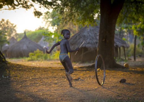 Anuak Child Girl Playing With A Wheel In Abobo, The Former Anuak King Village, Gambela Region, Ethiopia