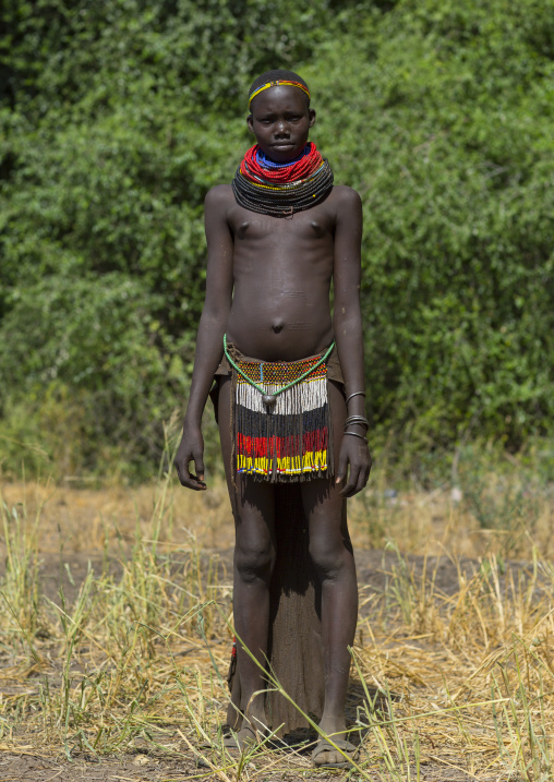 Portrait Of A Nyangatom Tribe Girl With Traditional Beaded Skirt, Omo Valley, Kangate, Ethiopia