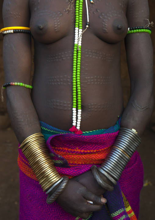 Portrait Of A Smiling Bodi Tribe Woman With Copper Bracelets, Hana Mursi, Omo Valley, Ethiopia