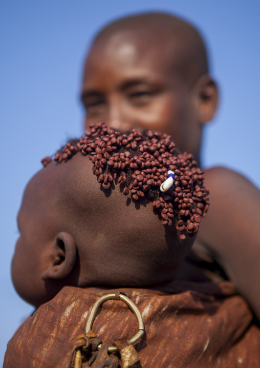 Portrait Of A Bodi Tribe Mother Carrying Her Baby, Hana Mursi, Omo Valley, Ethiopia