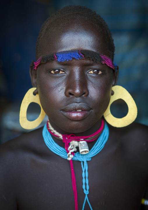 Portrait Of A Bodi Tribe Young Man With Huge Earrings, Hana Mursi, Omo Valley, Ethiopia