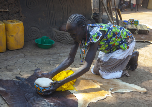 Anuak Tribe Woman Serving Food In The Tradtiional Way By Walking On Her Knees, Gambela, Ethiopia