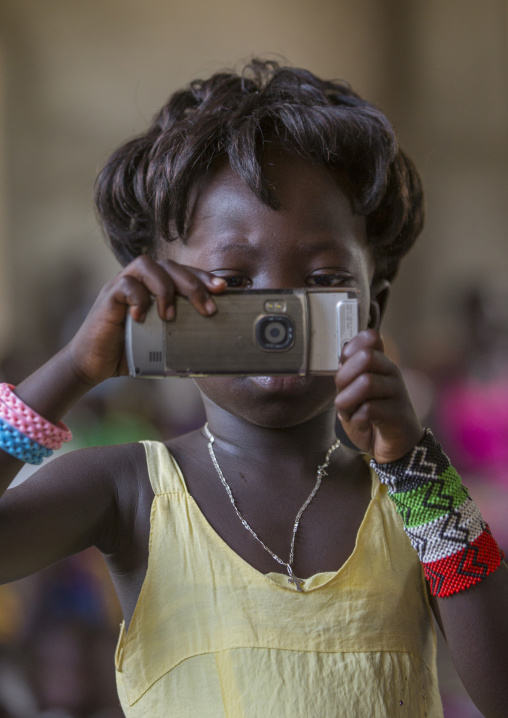 Girl Taking Pictures With Her Mobile Phone During A Catholic Sunday Church Service, Gambela, Ethiopia