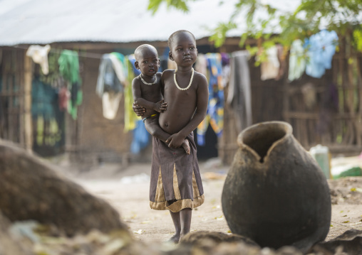 Anuak Child Carrying A Baby In A Market, Gambela, Ethiopia