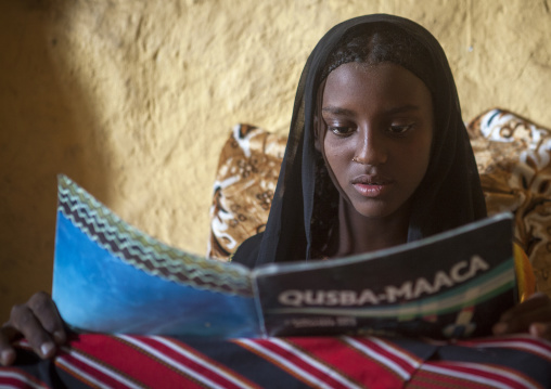 Fatouma Mahammed From Afar Tribe Reading A School Book, Afambo, Ethiopia
