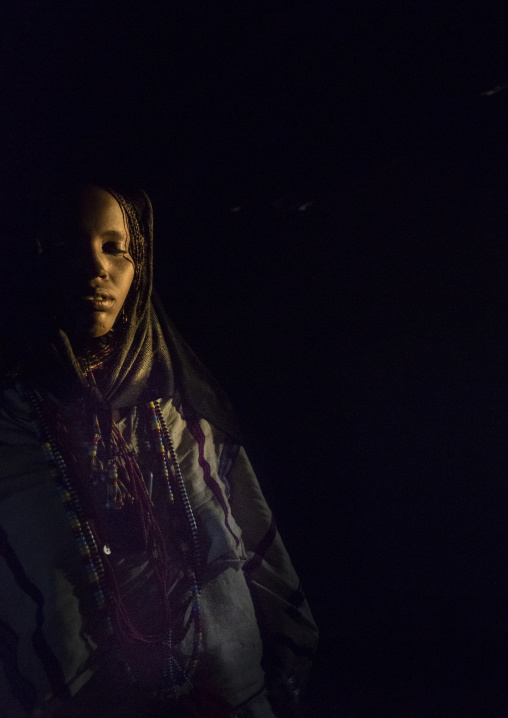 Karrayyu Tribe Woman Inside Her House Lighten By A Ray Of Light, Metahara, Ethiopia