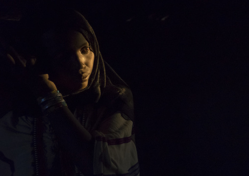 Karrayyu Tribe Woman Inside Her House Lighten By A Ray Of Light, Metahara, Ethiopia