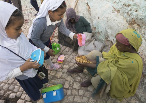 Children Giving Food To A Poor Beggar In The Street, Harar, Ethiopia