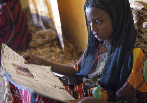 Fatouma Mahammed From Afar Tribe Reading A School Book, Afambo, Ethiopia