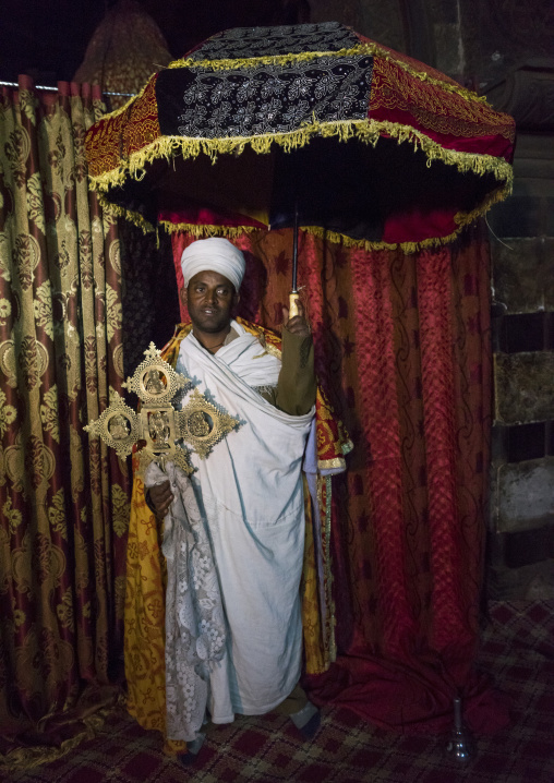 Priest Holding A Cross Inside Yemrehana Krestos Rock Church, Lalibela, Ethiopia