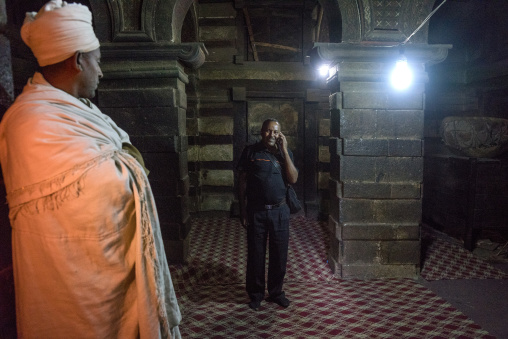 Tourist Making A Phone Call Inside Yemrehana Krestos Rock Church, Lalibela, Ethiopia
