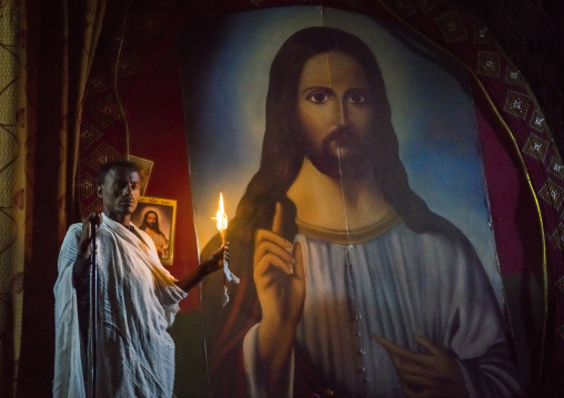 Priest Holding A Candle Inside A Rock Church, Lalibela, Ethiopia