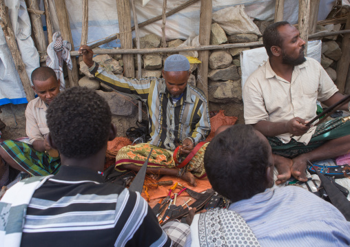 Afar tribe men making traditional knife called guile, Oromo, Sambate, Ethiopia